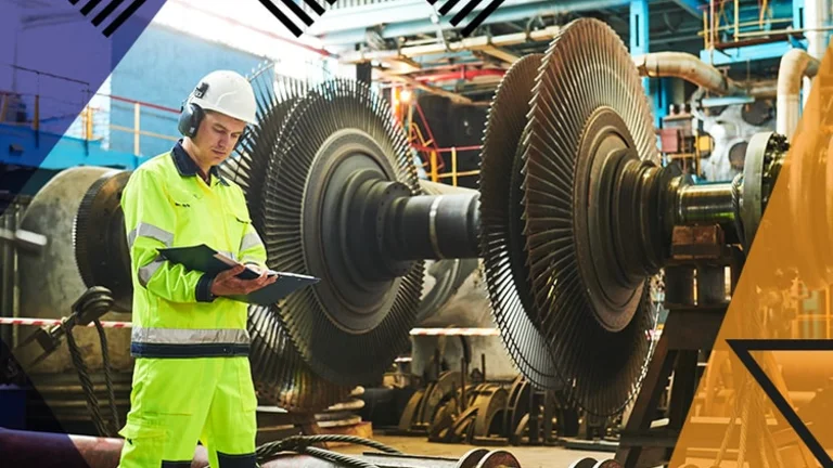 Make UK branded. Man in manufacturing setting standing in front of large construction