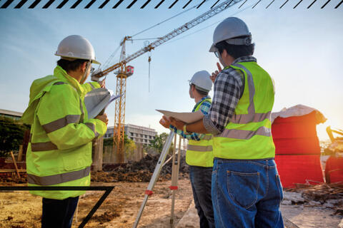 Three people looking over a construction site